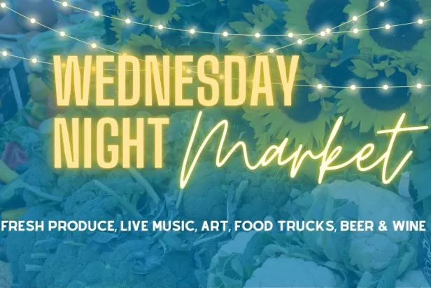 Blue background with lights and neon yellow text spelling out Wednesday Night Market